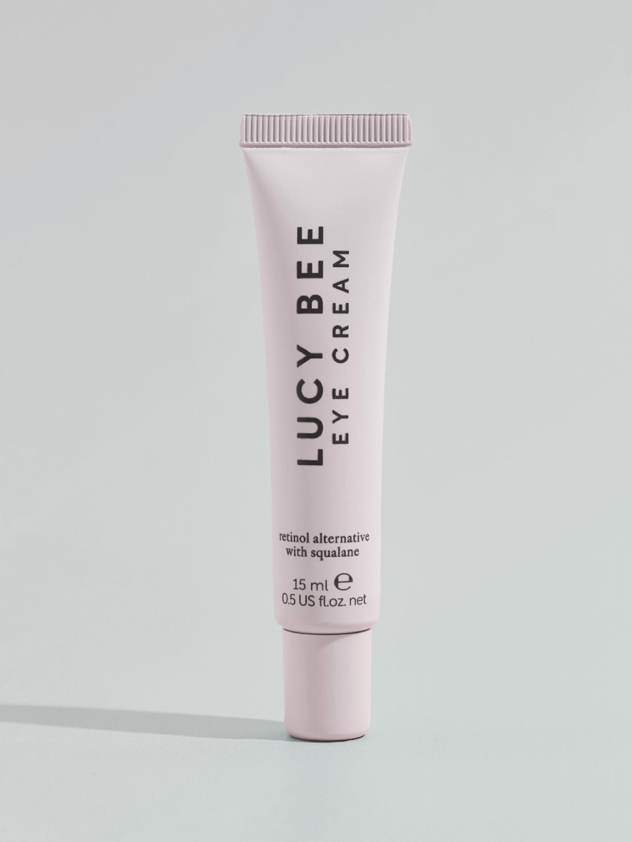 Lucy Bee eye cream tube on a light gray background