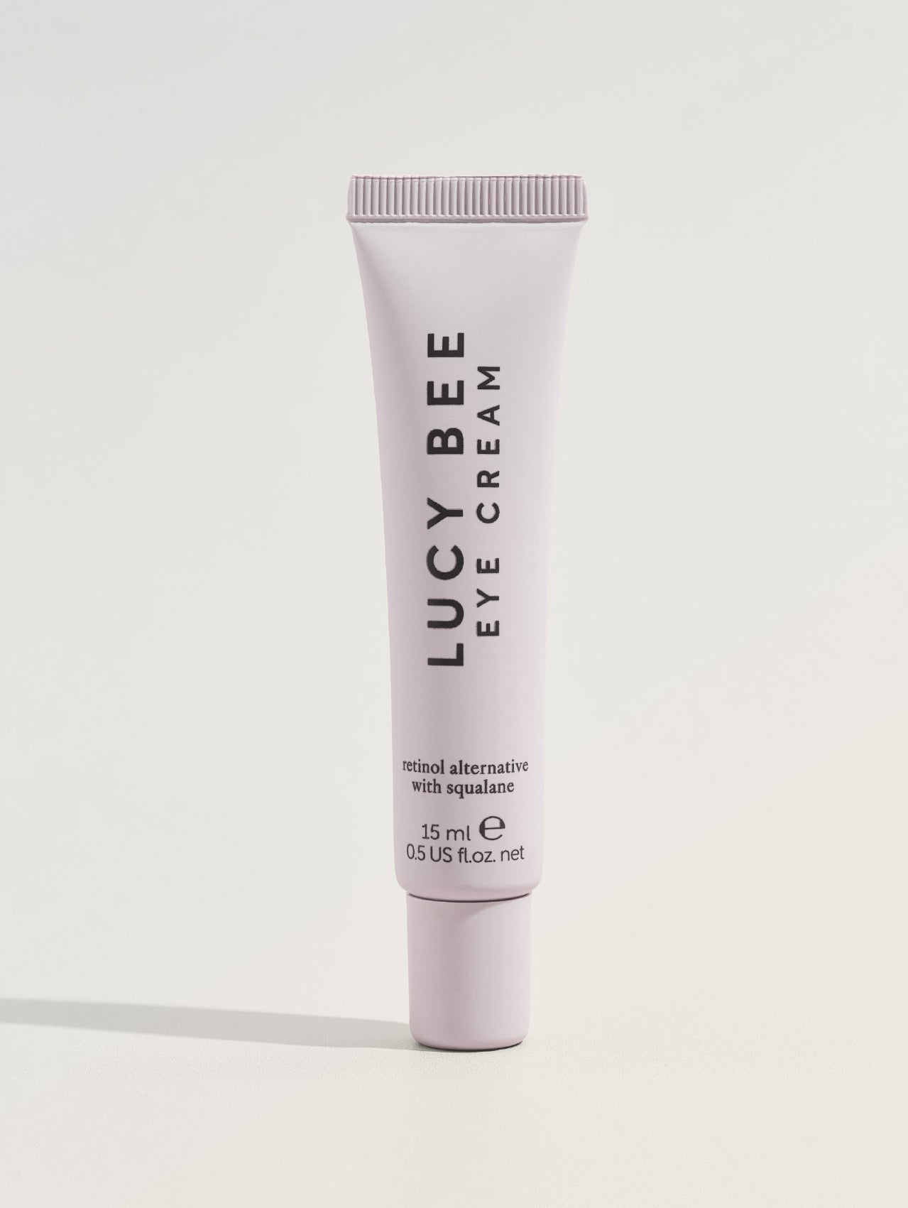 Lucy Bee eye cream tube on a white background