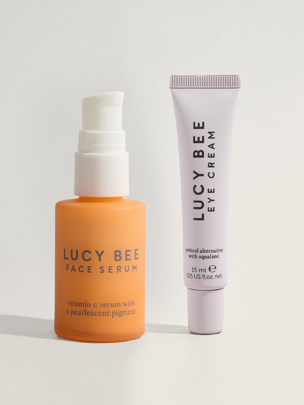 Lucy Bee face serum and eye cream on a light gray background