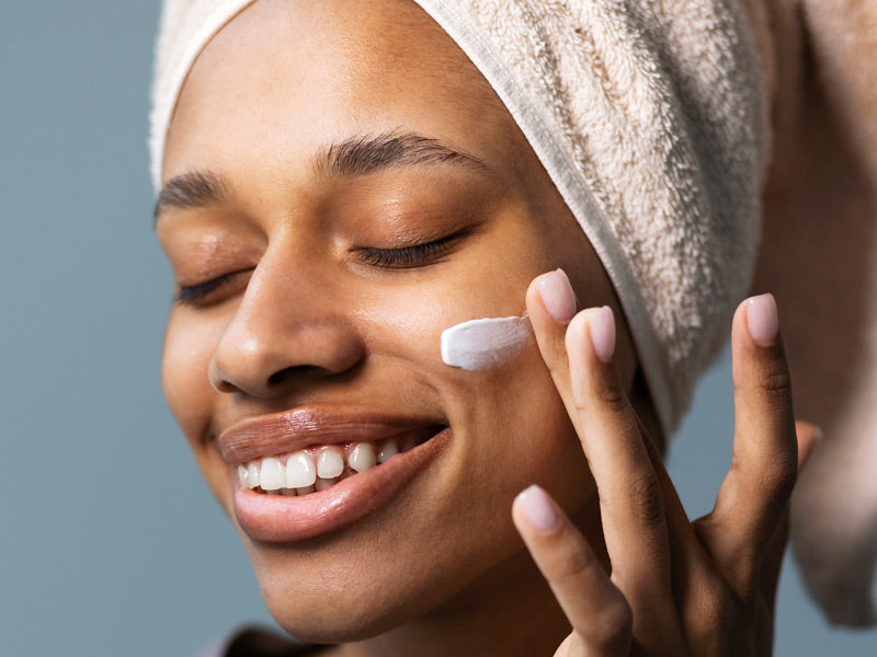 Woman applying Lucy Bee Ceramides Face Cream