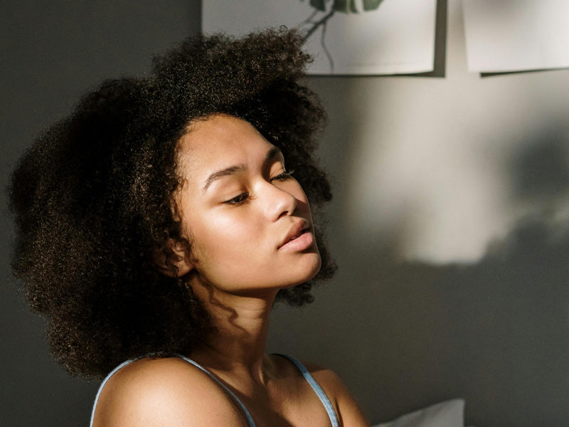 Woman with glowing, healthy skin in soft natural light