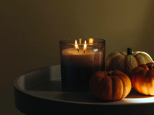 transitioning your skincare for autumn, autumn scene with candle and pumpkins