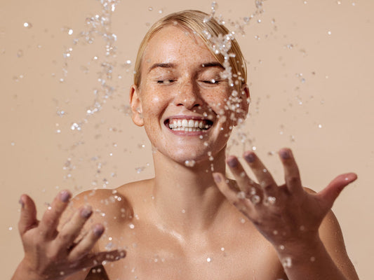woman washing face with fragrance free skincare for sensitive skin