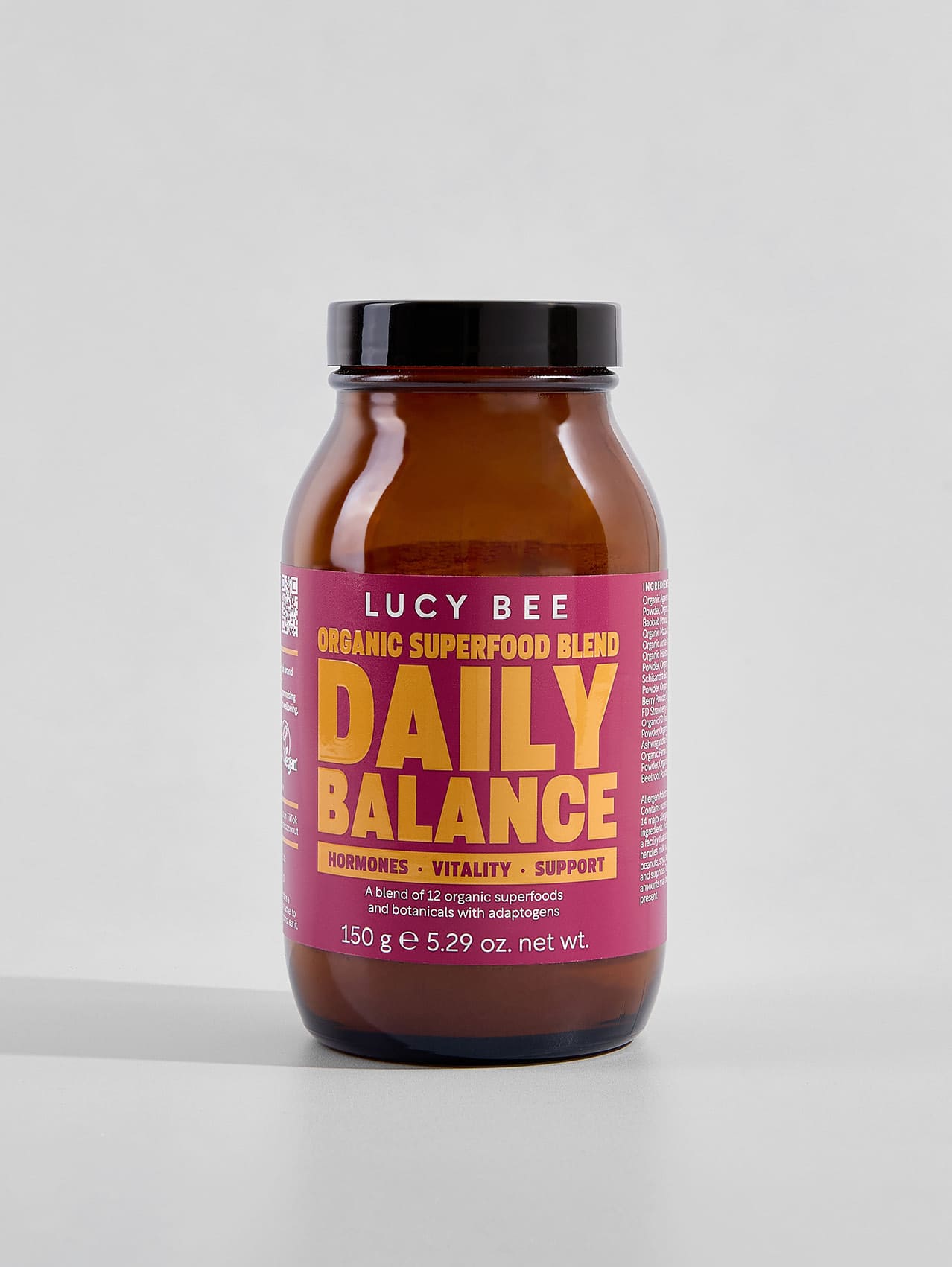 Lucy Bee Daily Balance superfood blend jar on a light gray background. Lucy Bee organic daily balance to support stress and times when you may feel out of balance