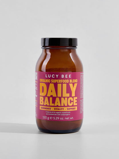 Lucy Bee Daily Balance superfood blend jar on a light gray background. Lucy Bee organic daily balance to support stress and times when you may feel out of balance