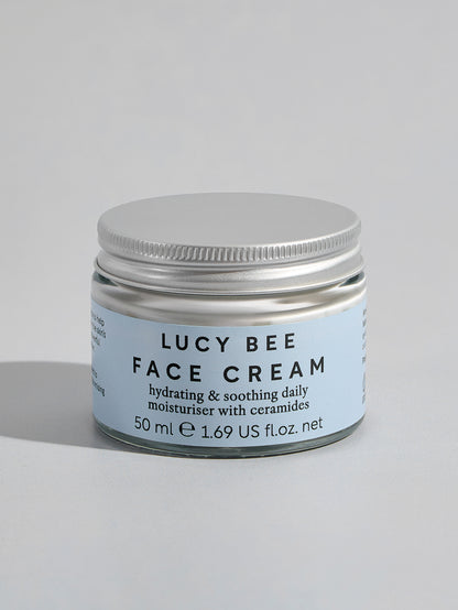 Jar of Lucy Bee Face Cream on a light gray background
