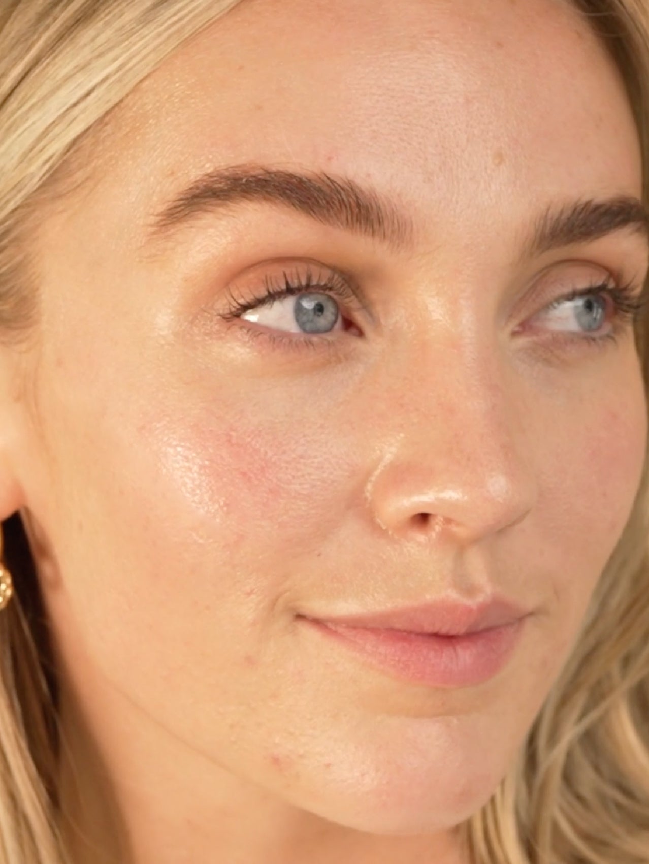 Close-up of a person's face with blonde hair and blue eyes.