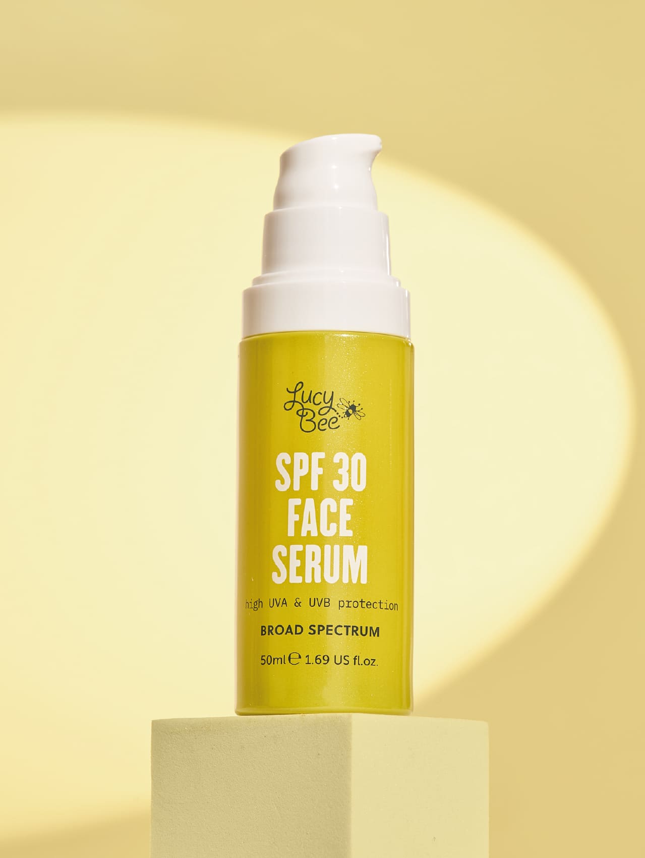 Lucy Bee SPF 30 Face Serum bottle on a yellow background