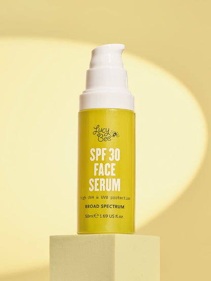 Lucy Bee SPF 30 Face Serum bottle on a yellow background
