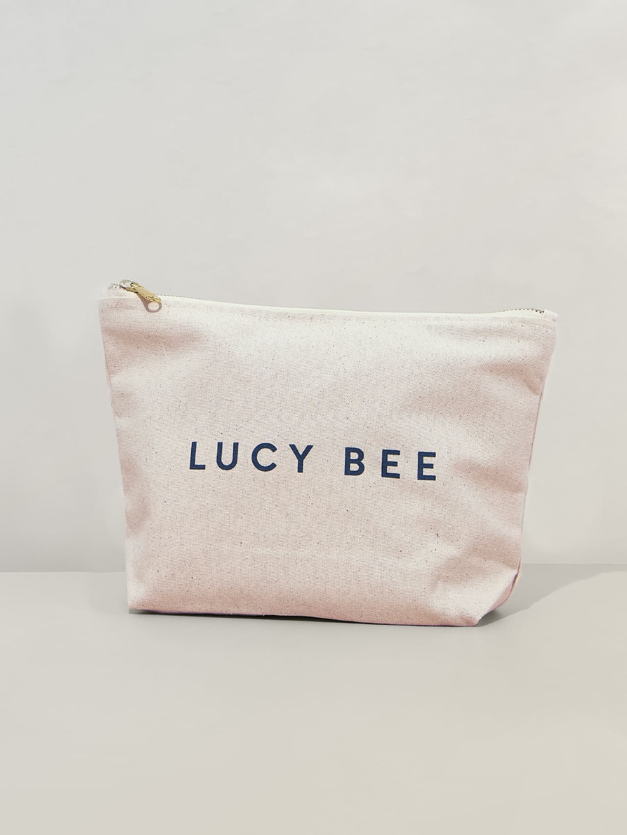 LUCY BEE branding on Travel Bag on a light gray background
