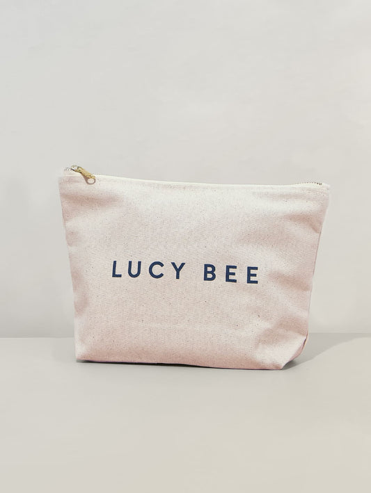 LUCY BEE branding on Travel Bag on a light gray background