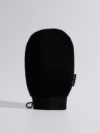 Black exfoliating mitt on a light gray background