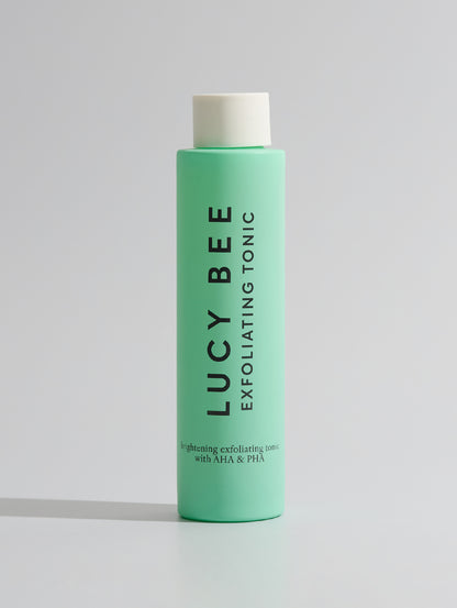 Green bottle of Lucy Bee Exfoliating Tonic on a white background