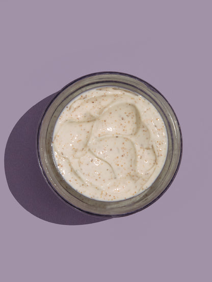 Jar of face scrub on a purple background