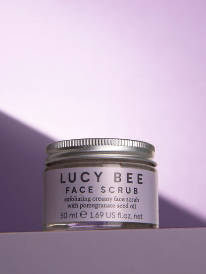 Jar of Lucy Bee face scrub on a purple background
