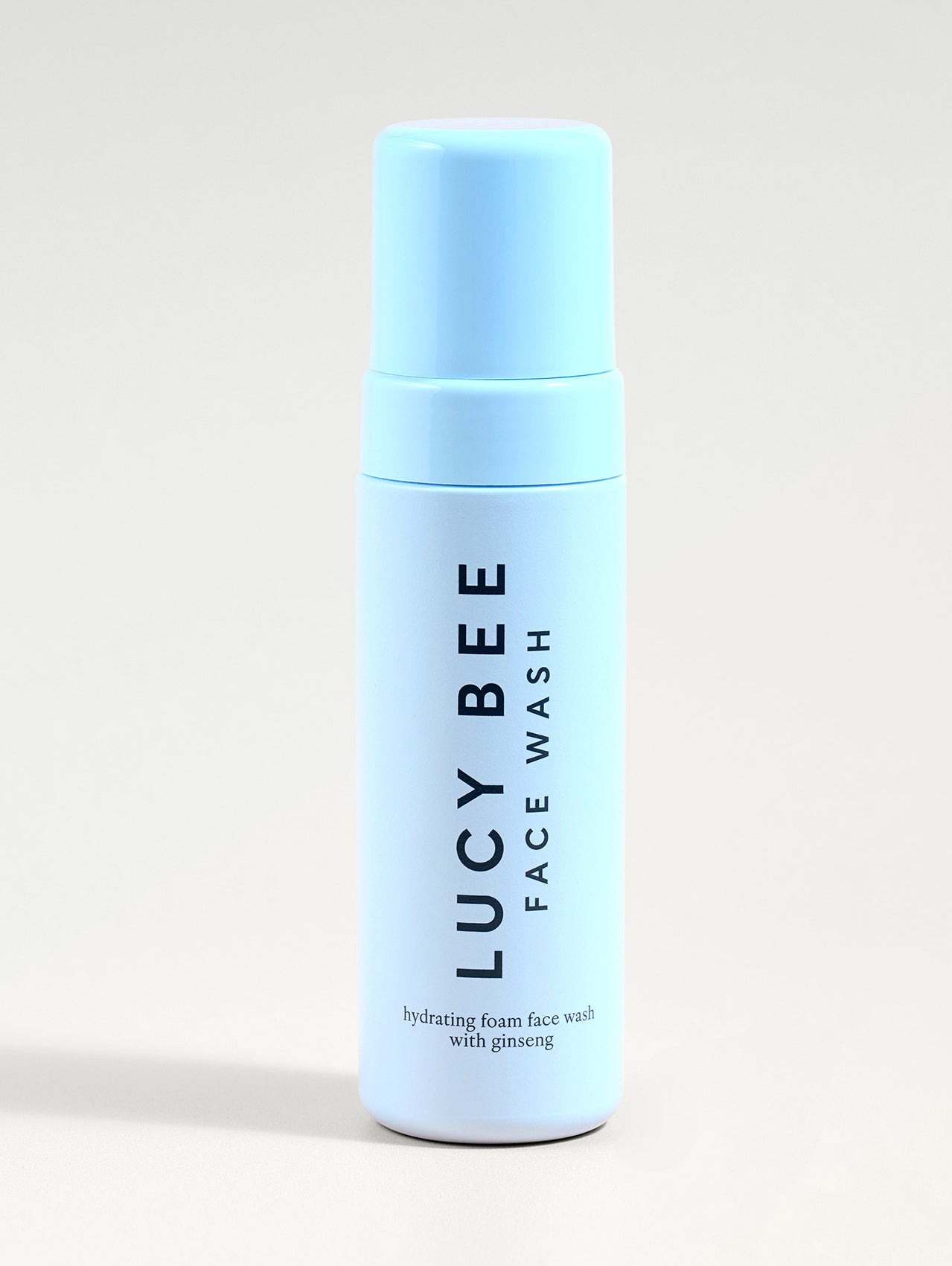 Lucy Bee face wash bottle on a light gray background
