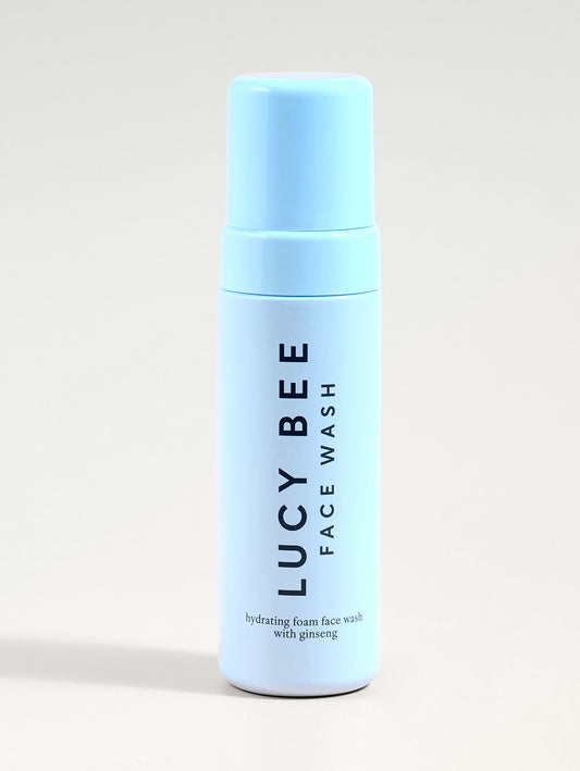 Lucy Bee face wash bottle on a light gray background