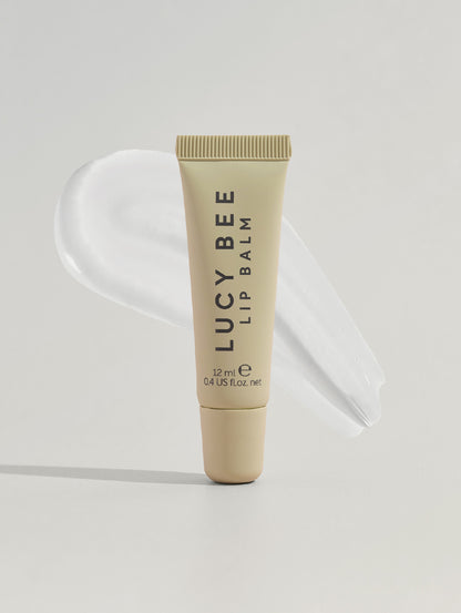 Lucy Bee lip balm tube on a light gray background