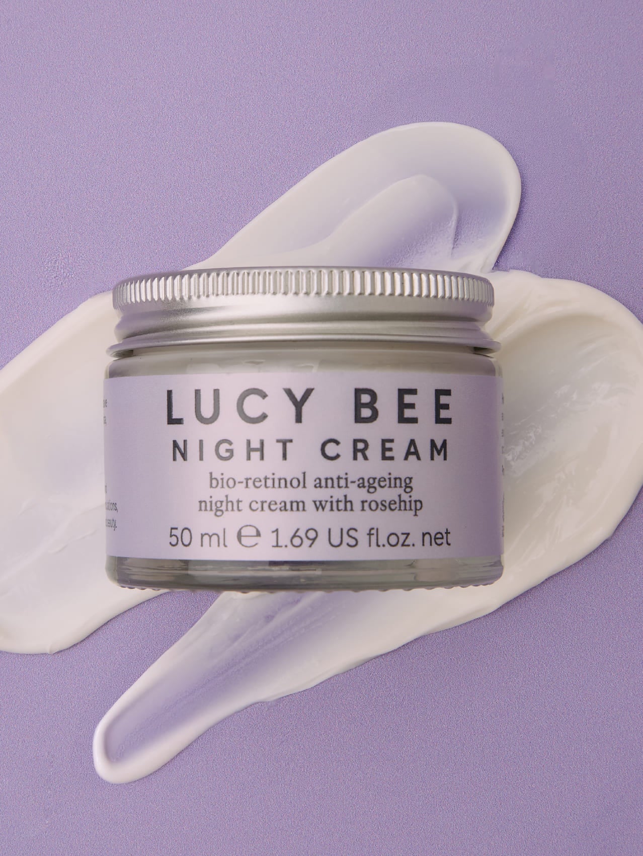Jar of Lucy Bee night cream with a purple background