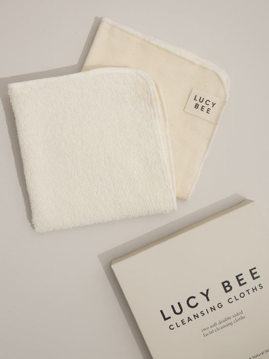 Two white Lucy Bee cleansing cloths and a box labeled