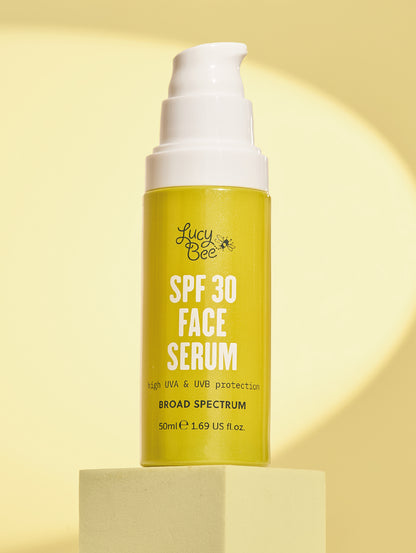 Lucy Bee SPF 30 Face Serum bottle on a yellow background