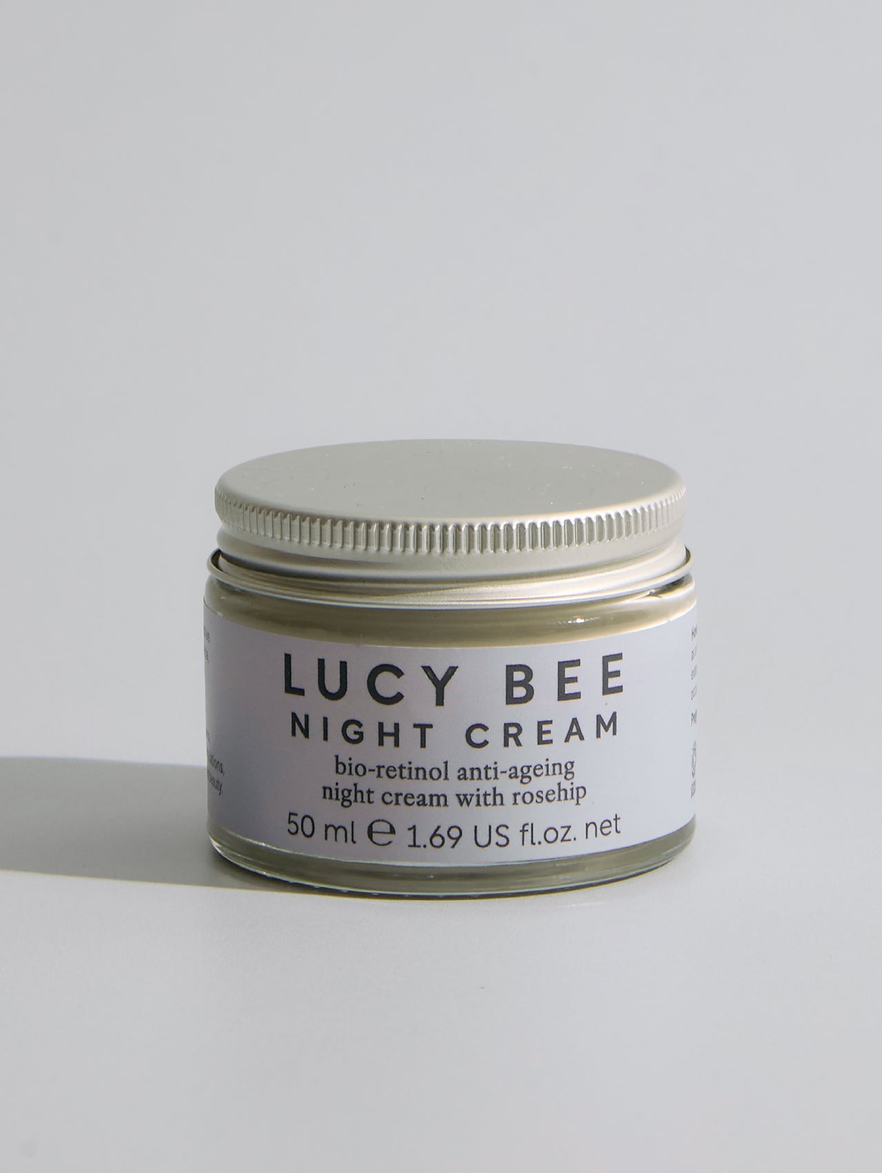 Jar of Lucy Bee Night Cream on a light gray background