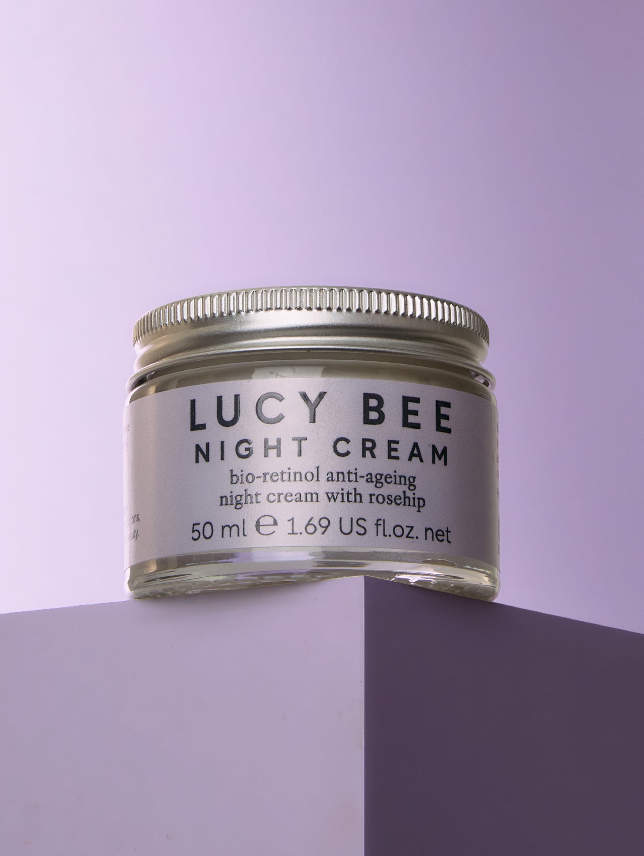 Jar of Lucy Bee Night Cream on a purple background