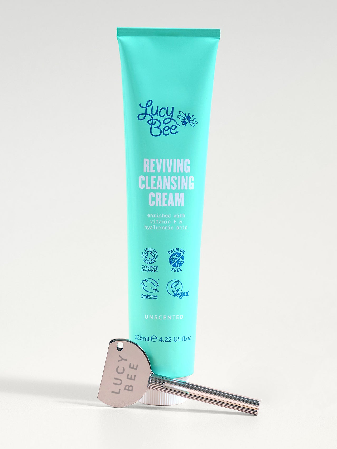 Tube of Lucy Bee Reviving Cleansing Cream with a silver tube turner on a white background