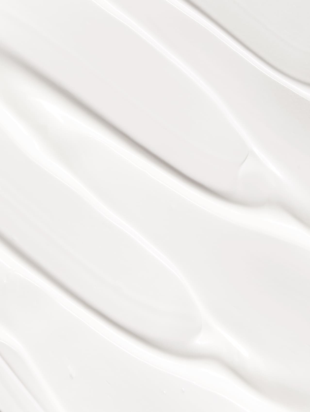 Close-up of white texture of cleansing cream with a subtle pattern