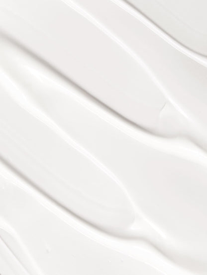 Close-up of white texture of cleansing cream with a subtle pattern