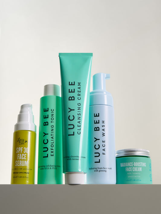 Set of Lucy Bee skincare products on a light gray background
