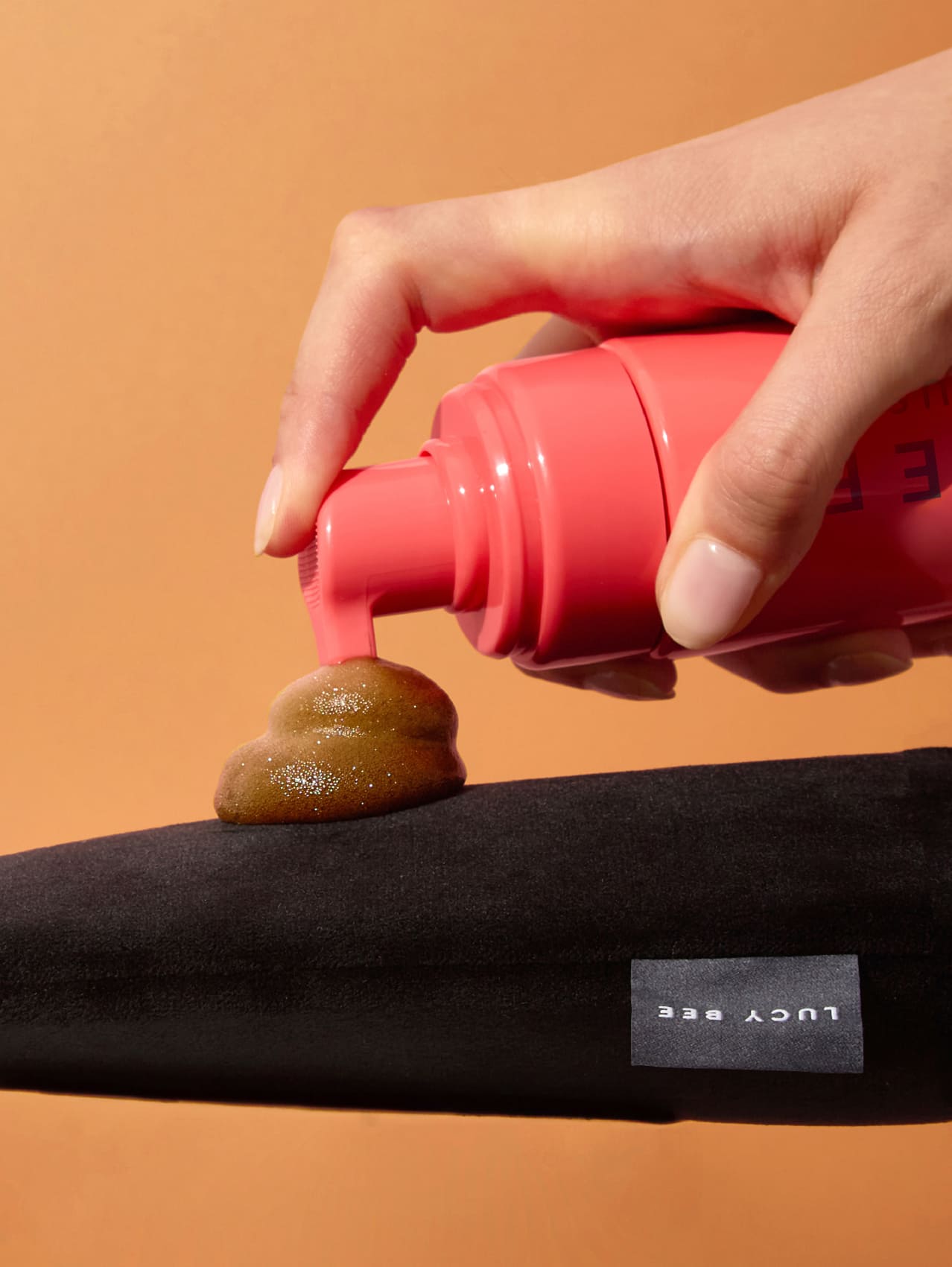 applying lucy bee self-tan mousse to mitt