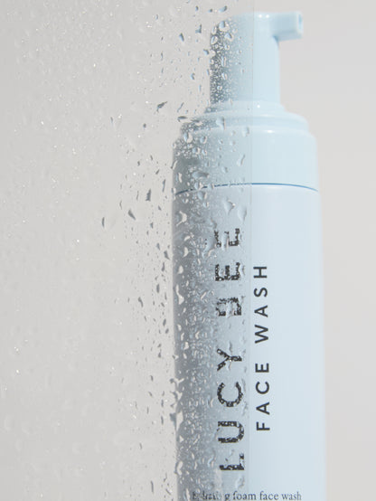 Lucy Bee face wash bottle with pump on a light gray background