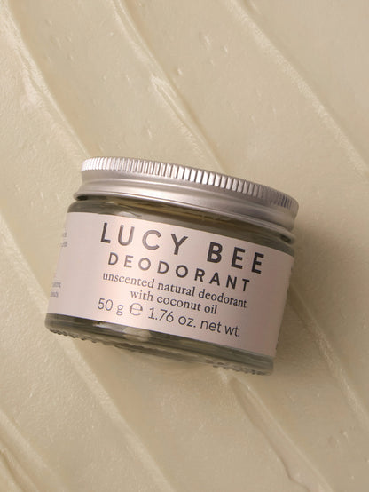 Lucy Bee deodorant jar on a textured beige background
